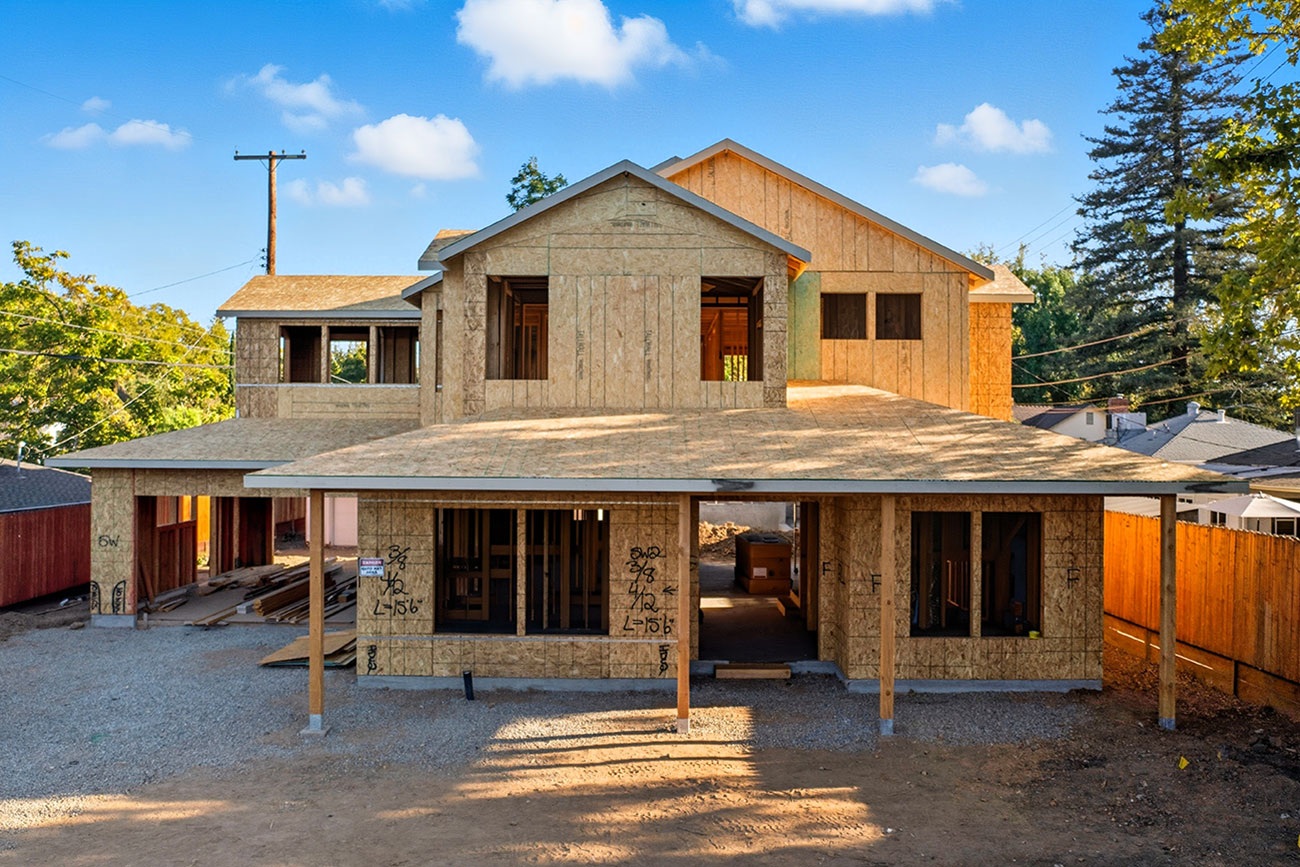 New home under construction with wood framing and garage