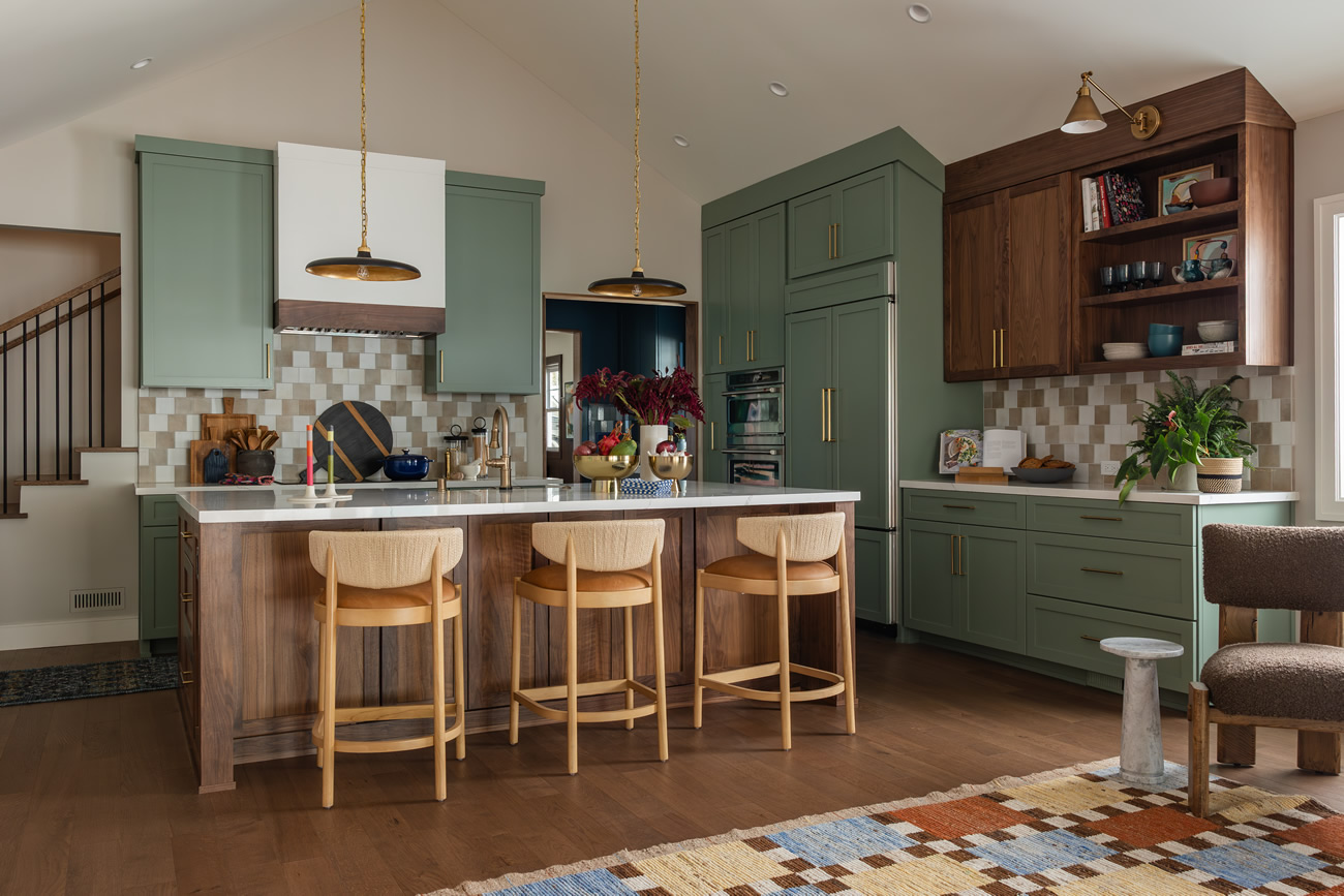 Kitchen with island, green cabinets and wood accents