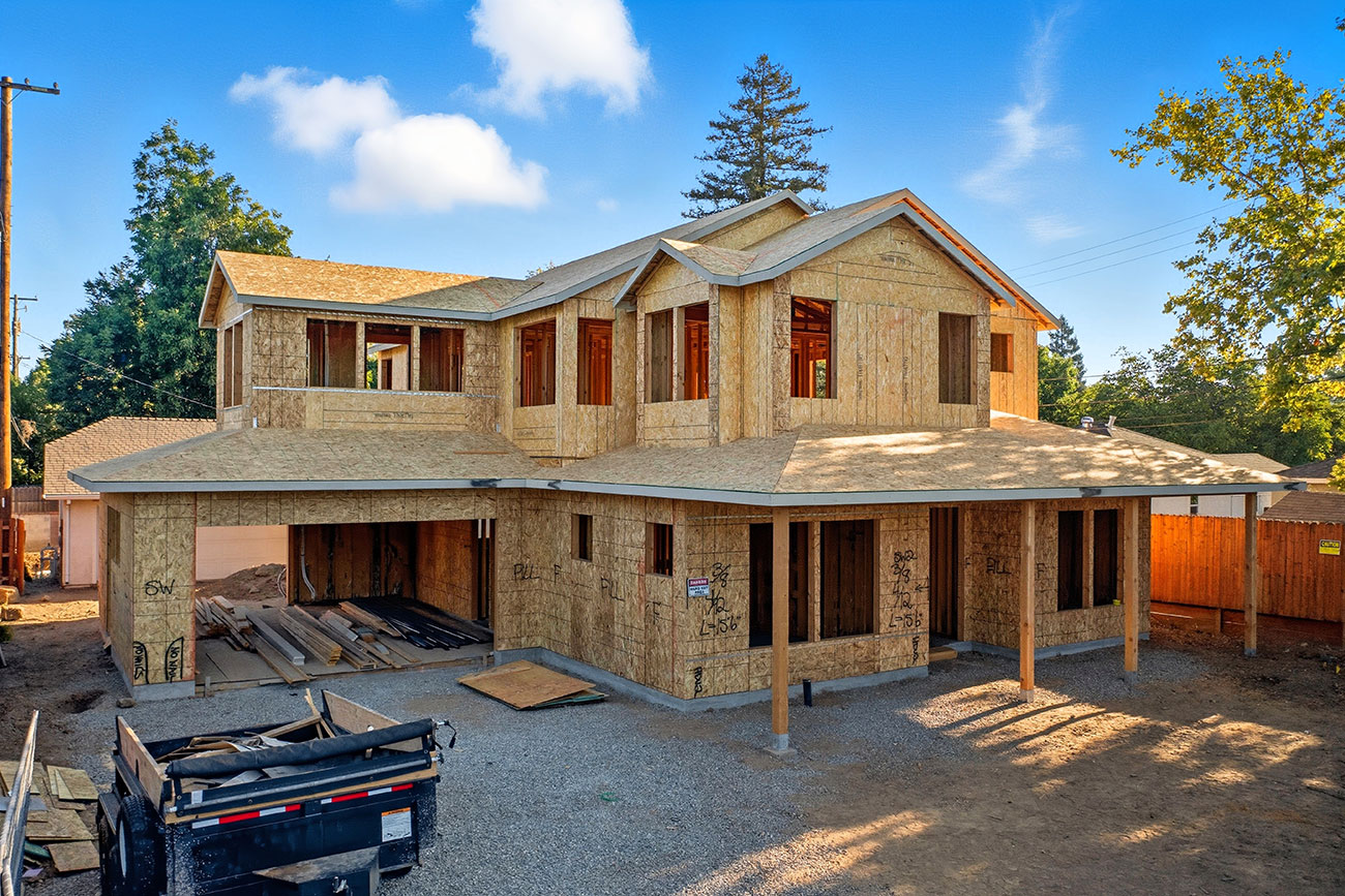 New home under construction with wood framing and garage